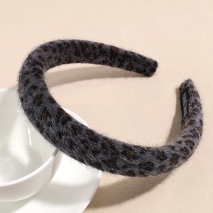 Close-up of leopard print headband with handmade label and soft faux mink texture