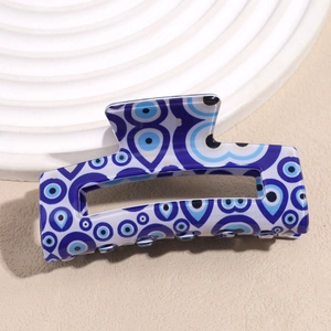 Detailed view of the rectangular hair claw clip with blue and white Evil Eye patterns