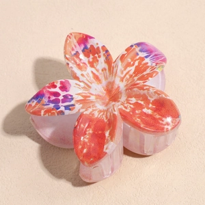 Detail of ABS lily flower hair claw featuring vibrant colorful tie-dye floral pattern