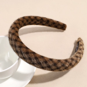 Macro view of plush leopard print headband resting on a ceramic cup for texture