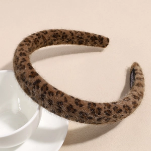 Detail of plush leopard print headband showing soft faux fur texture and non-slip inner lining