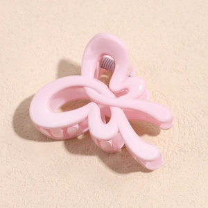 Elegant candy pink bow hair clip with a smooth glossy finish for women's hairstyling