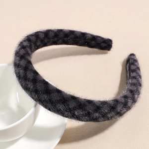 Detail view of plush dark gray leopard print headband with elegant woven diamond texture