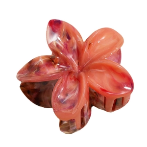 Elegant marble pattern frangipani flower hair claw clip with vibrant orange and purple tones