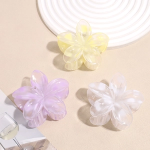 Floral hair claw clips in pastel yellow, purple, and white with matte frosted finish