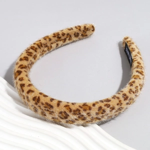 Detail shot of plush leopard print headband showing soft faux fur texture and hand made label