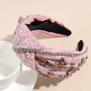 Detailed shot of pink velvet headband with sequins, silver rhinestones and crystal butterfly
