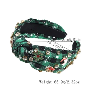 Close-up of Christmas headband with green plaid fabric, metal snowflakes and size labels