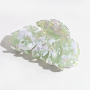 Detailed macro view of the monstera leaf hair claw with green marble acetate texture