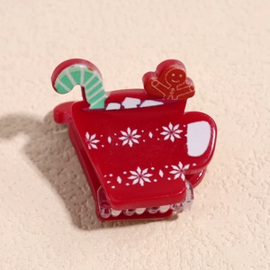 Détail de la pince à cheveux en résine de Noël avec bonhomme en pain d'épices et flocons