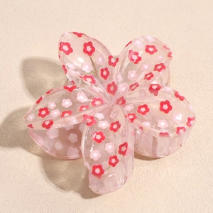 Dettaglio molletta per capelli rosa traslucida con piccoli fiori in resina lucida