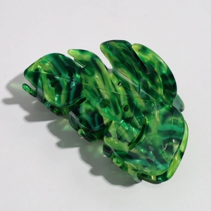 Detailed monstera leaf acetate hair claw clip featuring green tortoiseshell texture
