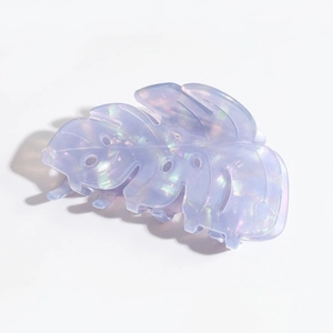 Detailed top view of a lavender acetate leaf hair claw with an iridescent pearlescent finish