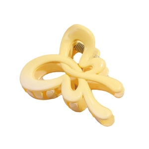 Elegant creamy yellow bow hair clip with durable resin finish for daily styling