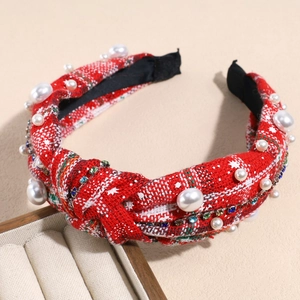 Close-up of red tweed headband with faux pearls and colorful rhinestone chain detail