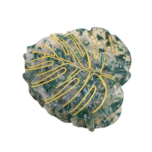 Elegant monstera leaf acetate hair claw clip with golden veins and marble texture