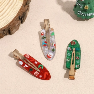 Three Christmas-themed glitter hair clips with Santa, snowflake and candy cane designs