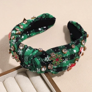 Detail of Christmas headband with green plaid fabric, rhinestones and festive charms