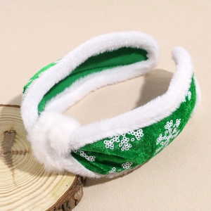 Detail view of green velvet headband with white plush trim and sparkling sequin snowflakes