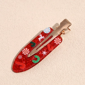 Detailed close-up of a festive Christmas duckbill clip with red sequins and holiday patterns