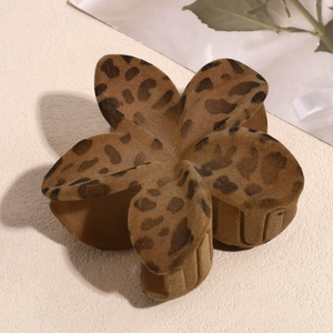 Detail of leopard print flower hair claw clip with soft flocked velvet texture