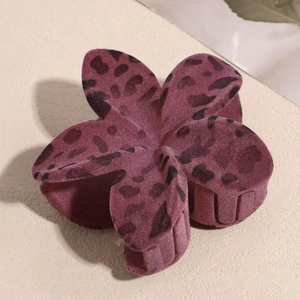 Detail of purple flocked flower hair claw clip with leopard spots and soft matte texture