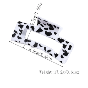 Detail view of large cow print rectangle hair claw clip with size measurements