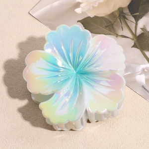 Detail view of large floral hair claw clip featuring a pastel gradient petal design