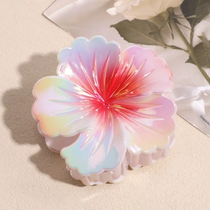 Macro shot of large floral hair claw clip in gradient colorful pearlescent resin