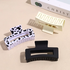 Three elegant hair claws in cow print, matte black and cream colors for thick hair
