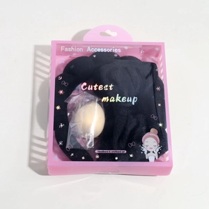 Pink gift set containing a black bow headband, wristbands, and a makeup sponge