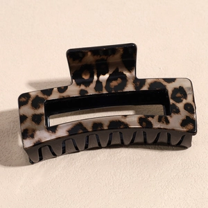 Detail of a rectangular leopard print hair claw clip with a glossy acrylic finish