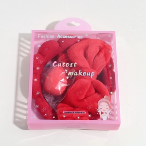 Red plush bow headband set with wristbands and makeup sponge in a pink gift box