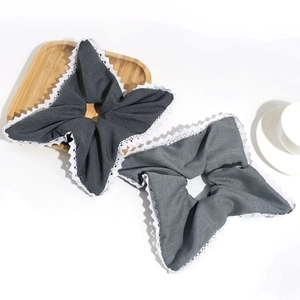 Lace-edged cloth scrunchies set in grey tones with artistic square star folding design