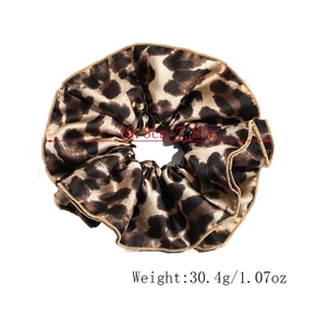 Detail view of oversized leopard print scrunchie showing 7.8 inch diameter and soft texture