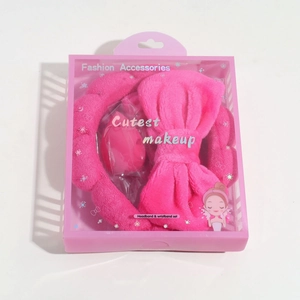 Pink plush spa headband and wristband set in transparent plastic display gift box