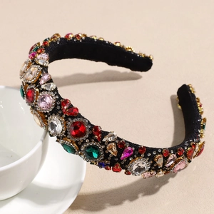 Detailed view of luxury wide headband featuring multi-colored rhinestones on a white cup