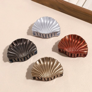 Shell shaped hair claw set in metallic gold, silver, and bronze colors for women
