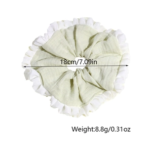 Detail view of large light green scrunchie with white ruffles showing 18cm diameter size