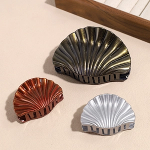 Three-piece shell hair claws set in black, bronze, and silver with glitter finish