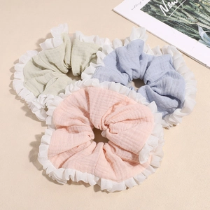 Three-pack of pastel cotton scrunchies with white pleated lace trim in pink green blue