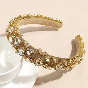 Detailed close-up of champagne rhinestones and gold woven texture on luxury headband