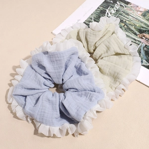 Pastel blue and sage green oversized linen scrunchies with white pleated lace trim