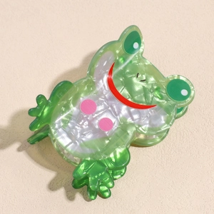 Nahaufnahme einer süßen grünen Haarklammer in Froschform aus perlmuttfarbenem Acetat
