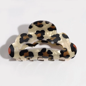 Detailed top view of a classic leopard print acetate hair claw clip on white background