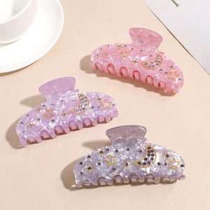 Three celestial acetate shark clips with stars, moon patterns and crystal rhinestones