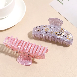 Elegant star and moon acetate shark hair clips in soft pink and purple with rhinestones