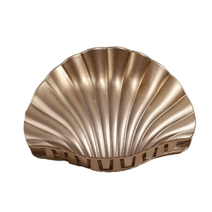 Elegant shell-shaped hair claw clip with champagne gold pearlescent finish on white background