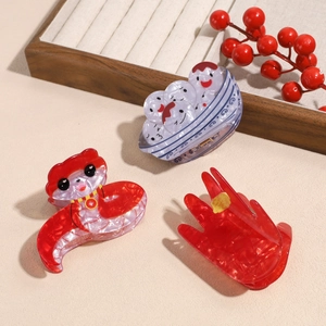 Chinese style red acetate hair claws featuring festive snake and tangyuan designs