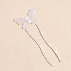 Detailed shot of pearlescent butterfly hair fork with U-shaped design and ivory resin finish